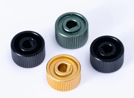 Four small control knobs with ridged outer surfaces
