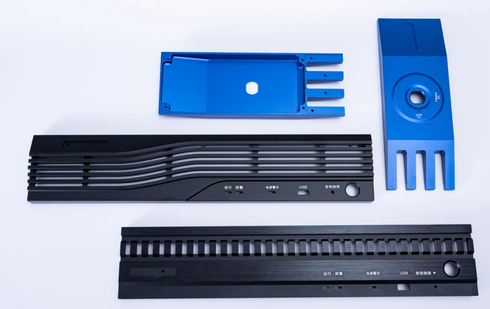 Blue and black machined control panels with slots and openings