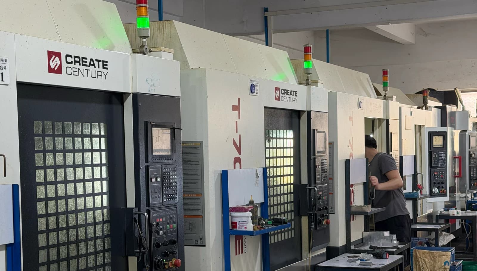 An operator working at a row of drilling and tapping centers in Yiwei’s workshop