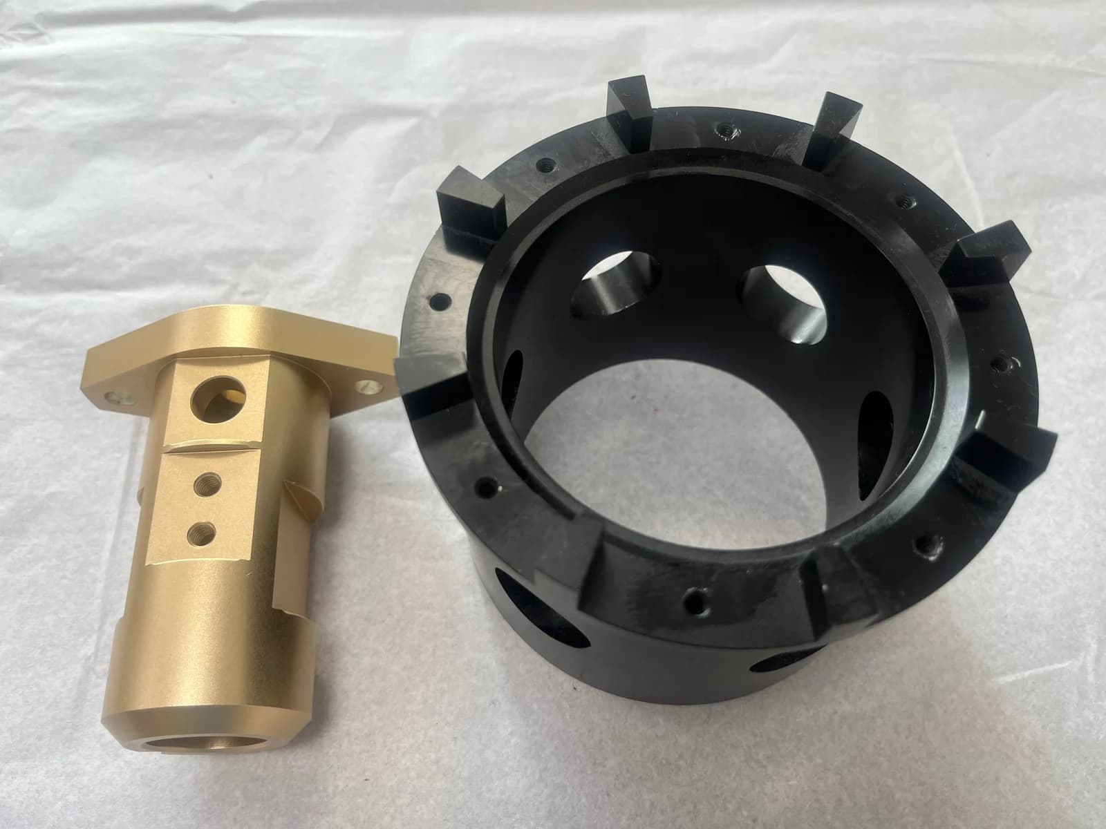 A black machined ring and a gold-colored component from Yiwei’s product collection