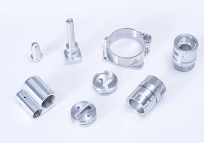 Machined cylindrical components, a ring housing and shafts
