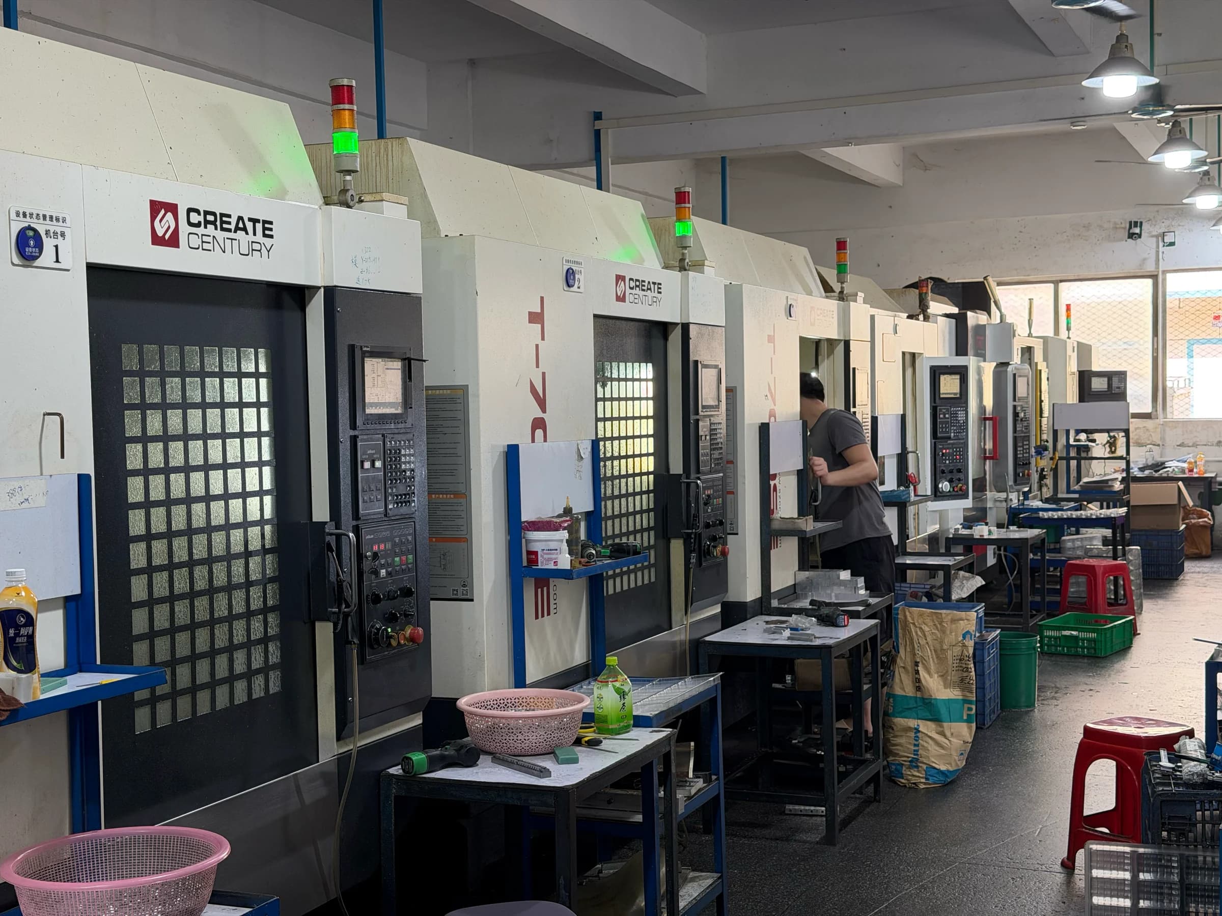 A row of drilling and tapping centers with an operator at work in Yiwei’s workshop